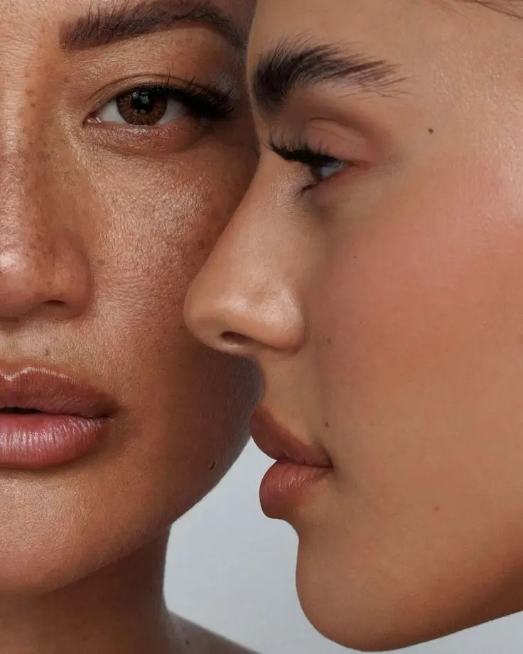 Close-up of two faces near each other, about to kiss, with noses and lips close together.