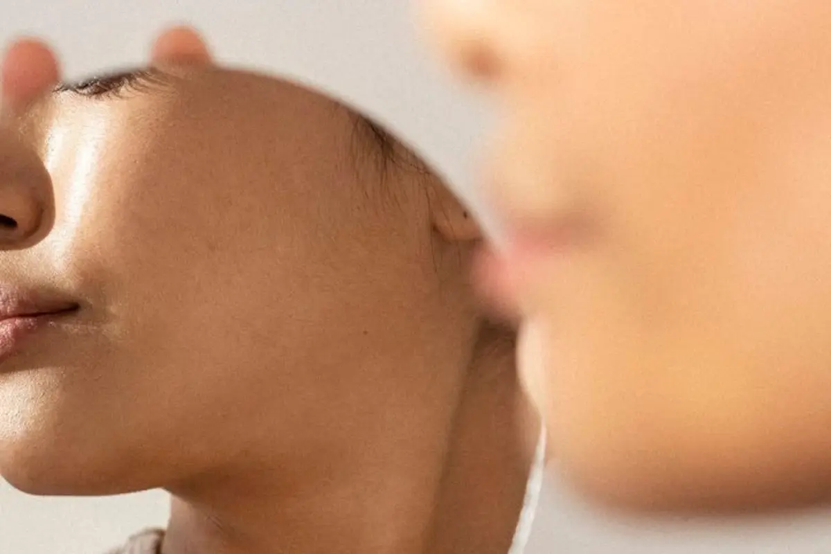Close-up of a sleeping infant's profile, showing lips, cheek, and soft skin in calm repose.