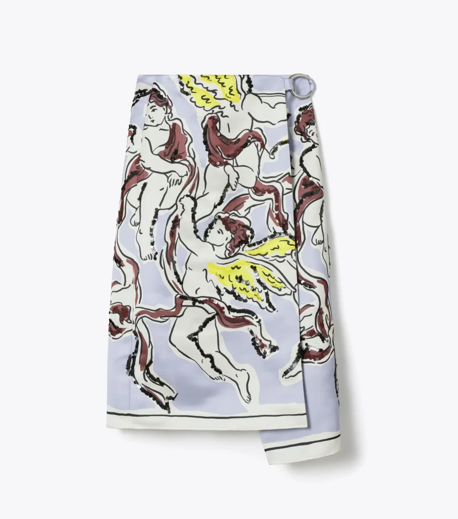 Light lavender wrap skirt featuring an abstract print of winged cherubs in red outlines with yellow wings.