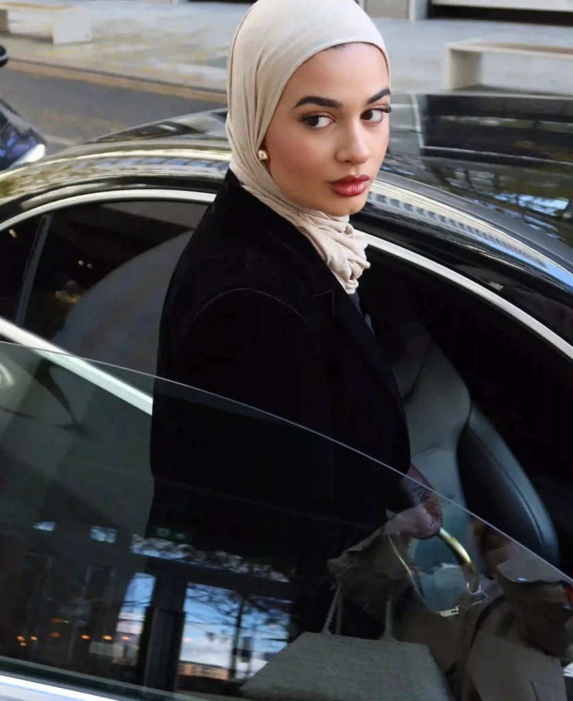 Image of Aminah Ali getting into a car