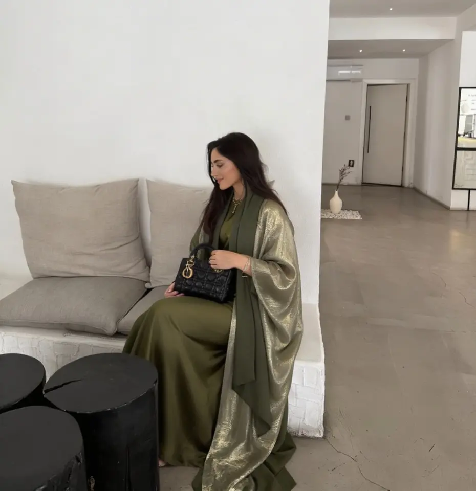 A woman wearing an abaya by Fdeit for our UAE-Based abaya brands roundup