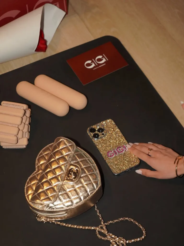 Gigi - Soigné Middle East Image of a Pilates mat with a Chanel bag and bedazzled phone case at Gigi Studios