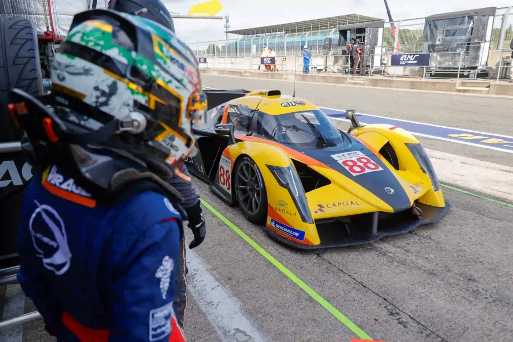 Image of Hamda Al Qubaisi at the paddock looking at her car