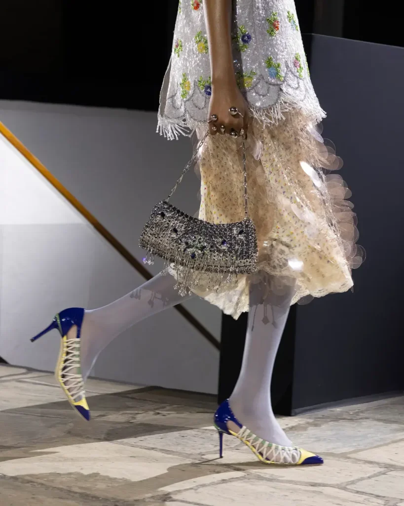 A close up shot of a model walking the Rabanne AW26 show.