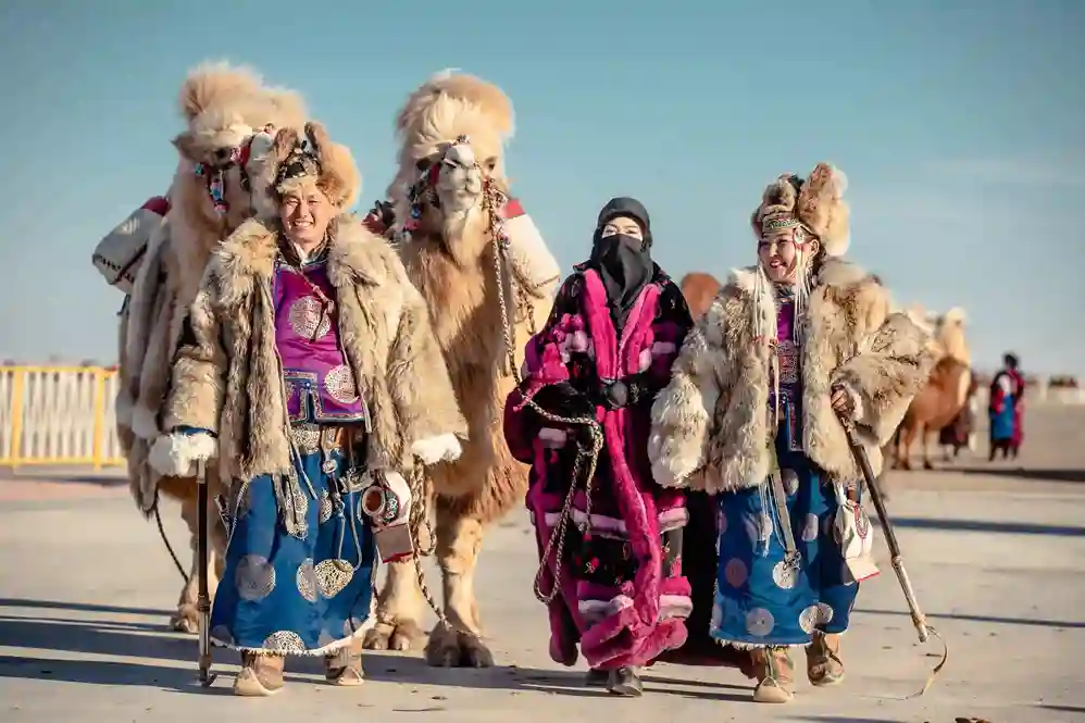 Salma in Mongolia with camels and people in their traditional dress