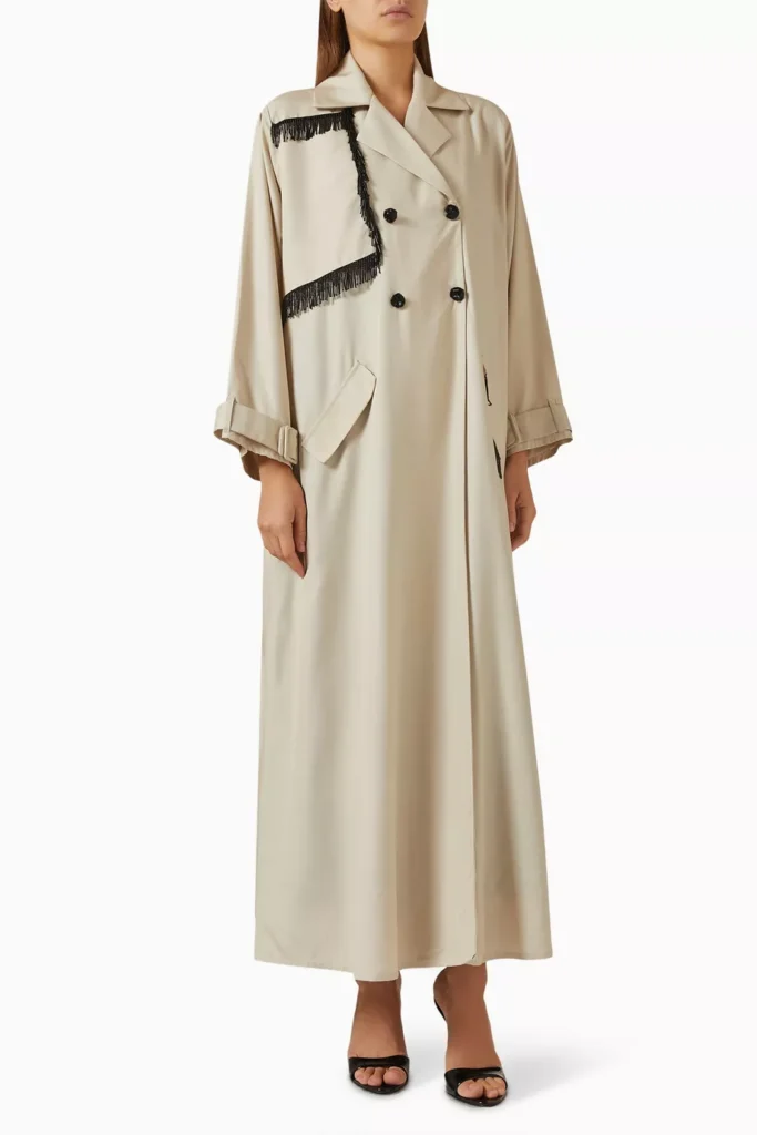 A model image of the Fringe Trench Coat Abaya by Beige Collection