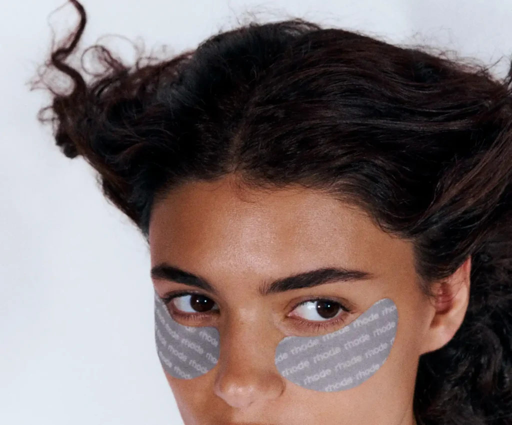 A model wearing the rhode under-eye patches, for our under-eye patch selfies article