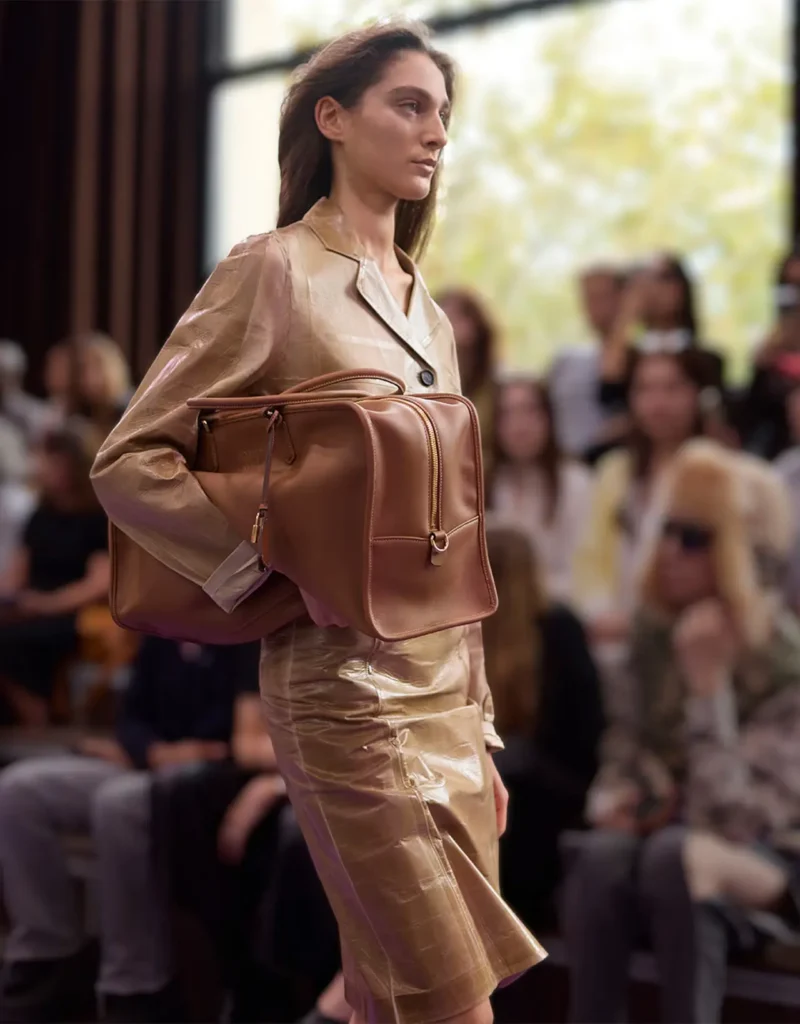 image of a model carrying a miu miu bag at the Miu Miu SS27 show